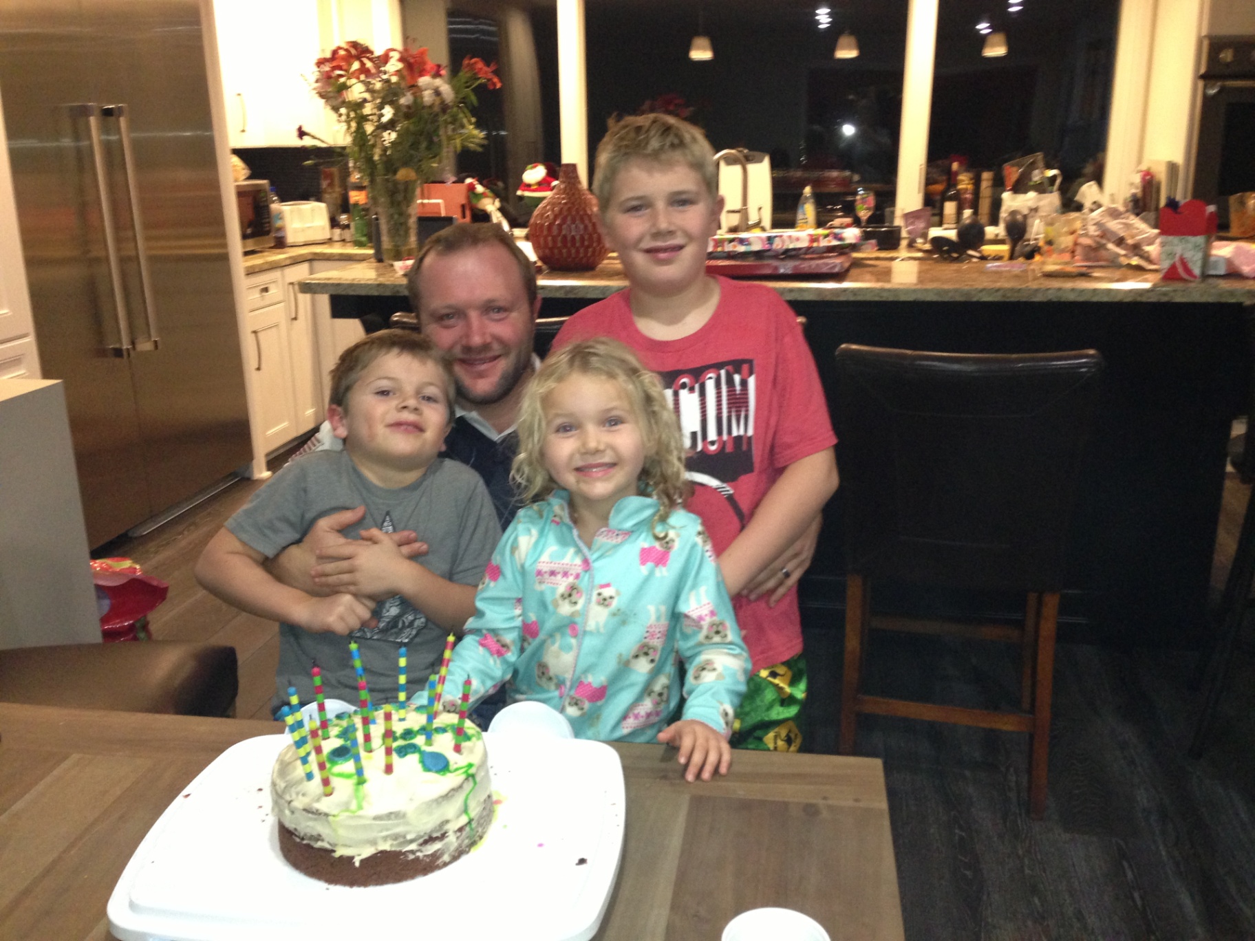 Indi with dad and brothers by a birthday cake