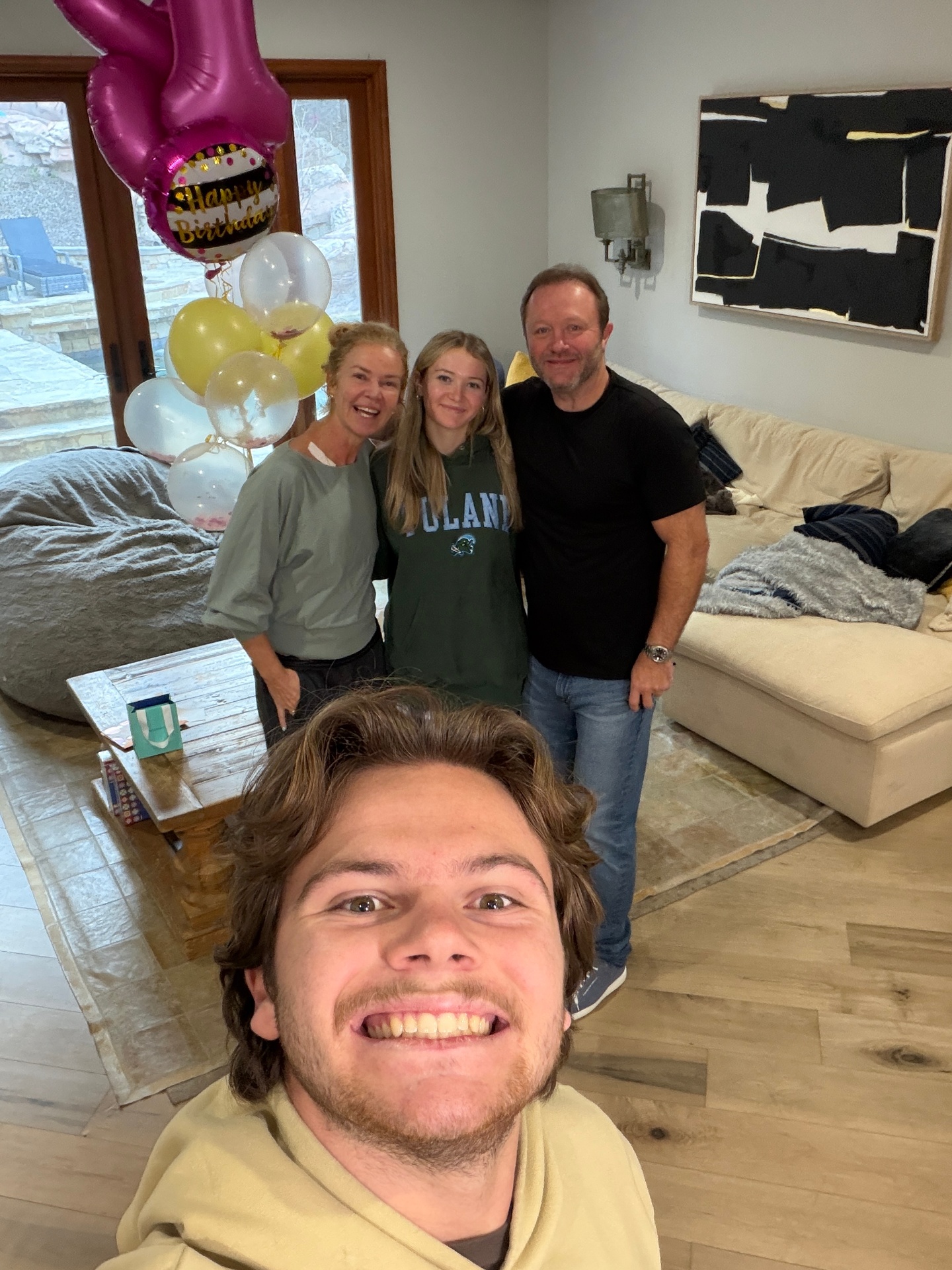 Indi celebrating a birthday with mom, dad and brother