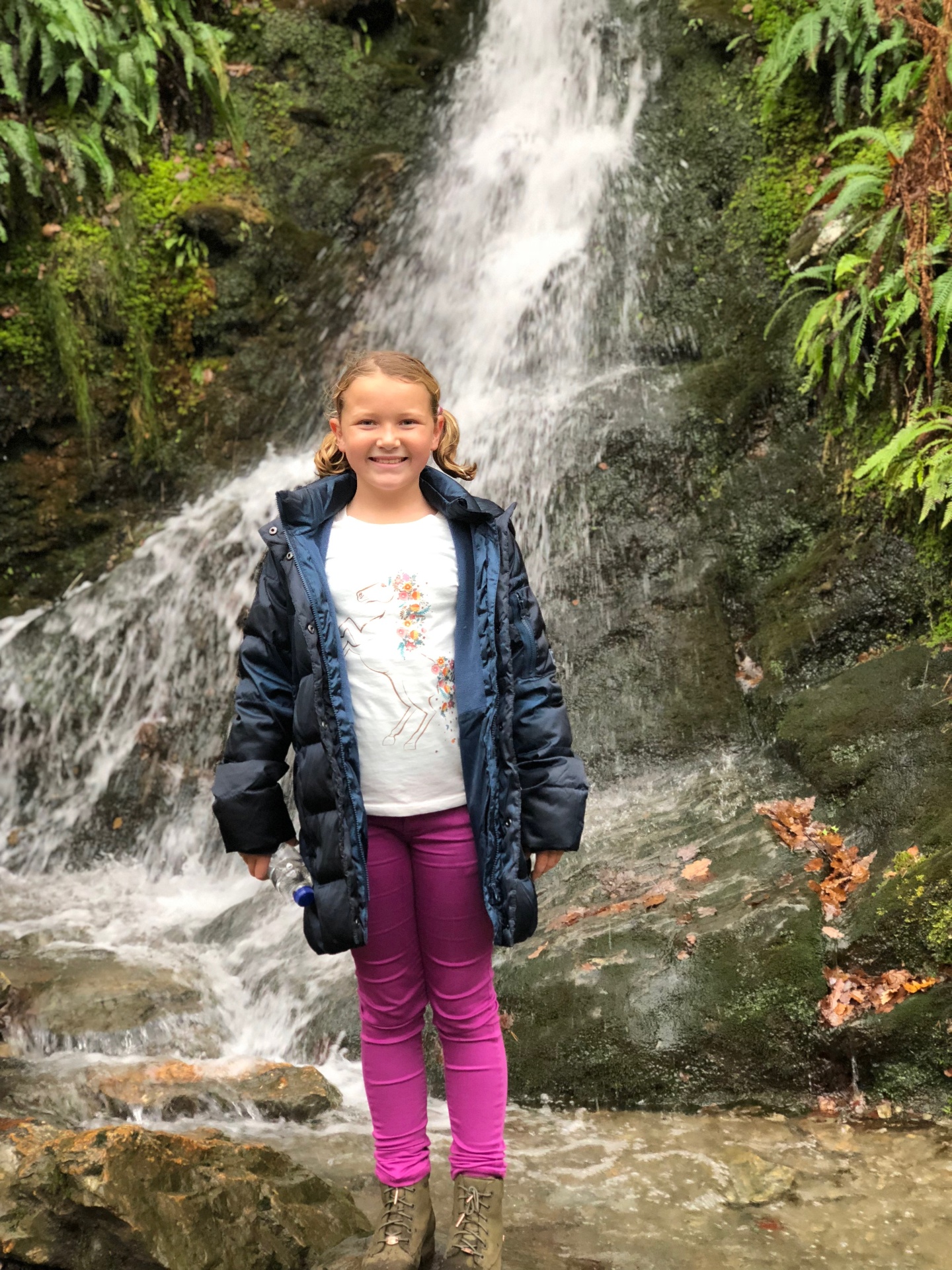 Indi in front of a waterfall